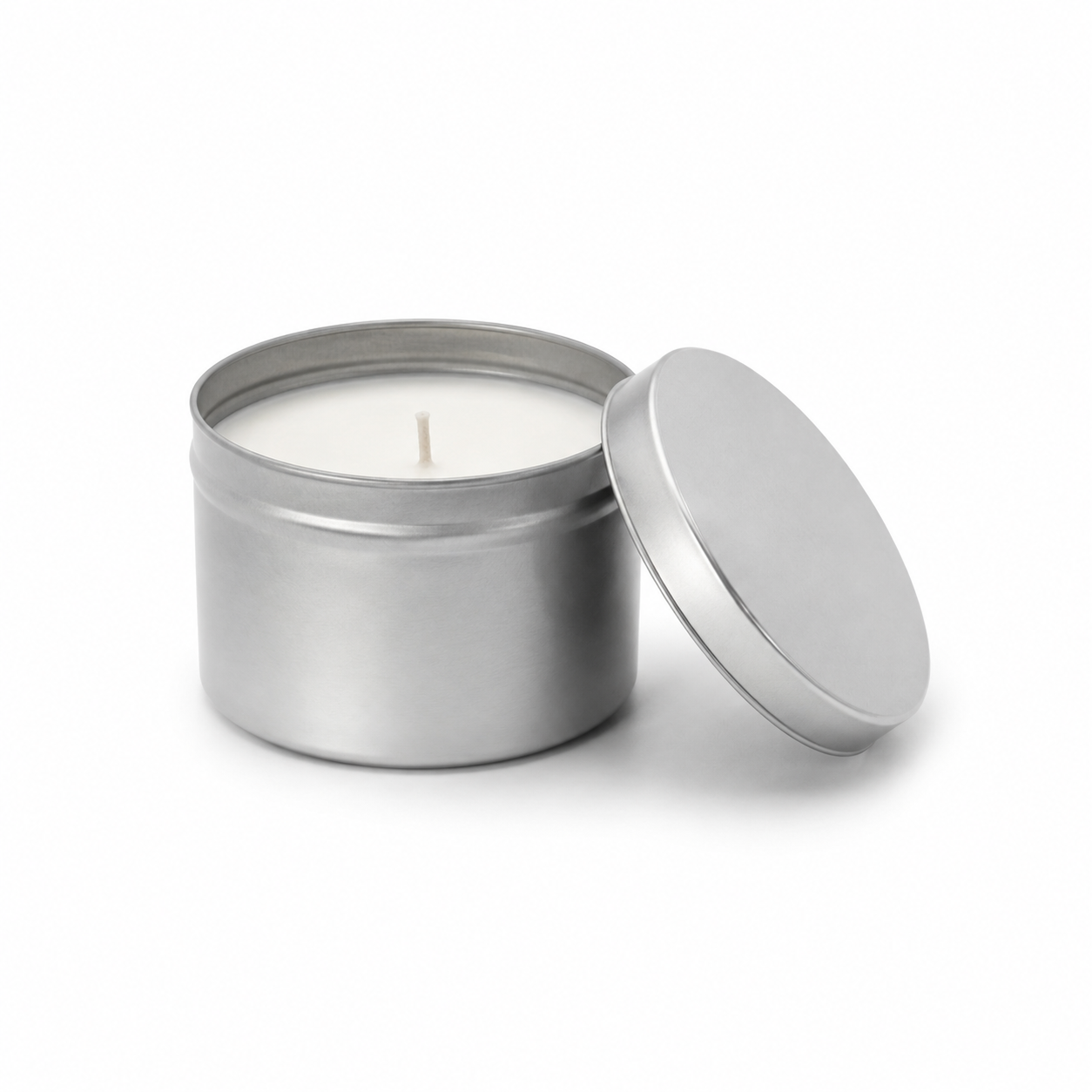 silver jar with white candle, lid off